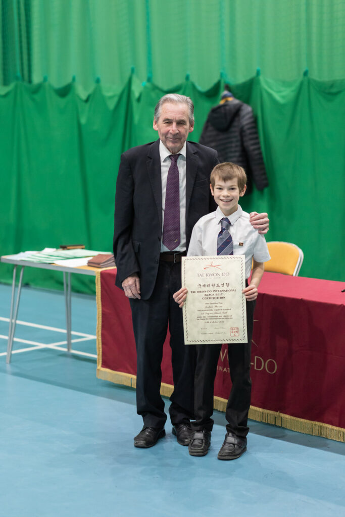 Tae Kwon Do Student presented with grading certificate